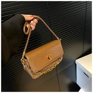 Detail of coffee brown shoulder bag with metallic gold chain and circular swivel lock
