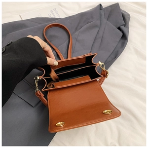 Top view of caramel brown crossbody bag showing interior compartments and zipper