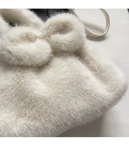 Detail shot of white plush bucket bag showing soft faux fur fabric and cute rabbit ear design