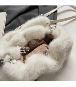 Detail of white plush bucket bag showing magnetic silver buckle and brown suede lining