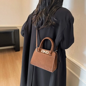 Brown frosted leather crossbody bag with silver turn-lock clasp shown on a model