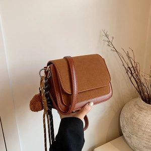 Brown minimalist square crossbody bag with suede patchwork and plush ball charm decoration