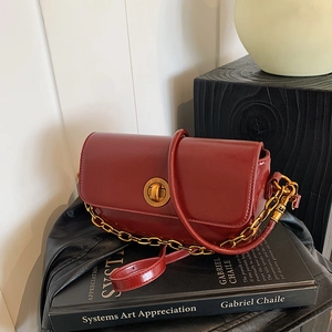 Modern burgundy rectangular crossbody bag with polished leather and gold chain strap