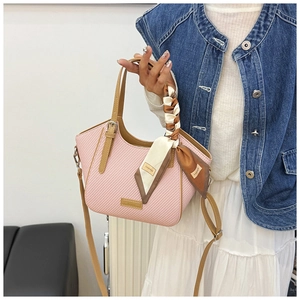 Pink and white houndstooth handbag with leather handles and decorative silk scarf