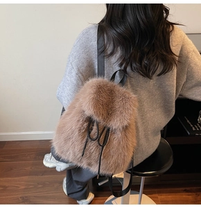 Close-up of fluffy faux fur texture on brown mini backpack with black leather straps