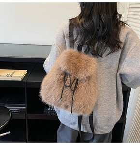 Detail of camel plush backpack with drawstring closure and soft faux fur texture