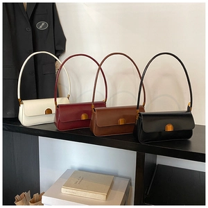 Four leather baguette shoulder bags in white, burgundy, brown and black with gold buckles