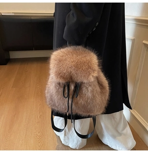 Detail of plush camel backpack with faux fur texture and black leather drawstring closure
