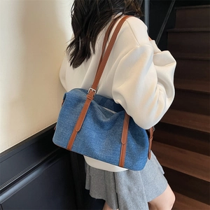 Fashionable denim shoulder bag with brown leather straps for daily casual commuting