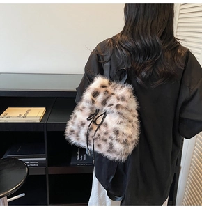 Detail of plush leopard print backpack with drawstring closure and soft faux fur texture