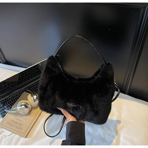 Detail shot of black plush faux fur hobo bag with love every day tag and leather strap