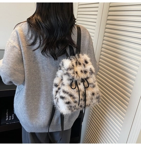 Close-up of leopard print faux fur backpack with black drawstring on model