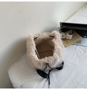 Close-up of beige faux fur backpack with black drawstring and high-quality texture