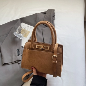 Retro matte brown handbag with gold hardware and shoulder strap on white background