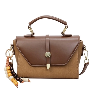 Sac à bandoulière vintage en toile bicolore et cuir avec boucle métallique ronde