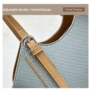 Detail view of adjustable leather strap with silver metal buckle on a woven bag