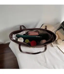 Detailed interior of a dark brown large tote bag showing ample space for daily essentials