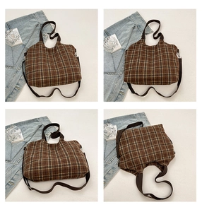 Detail of vintage brown plaid tote bag with wool texture fabric and adjustable strap