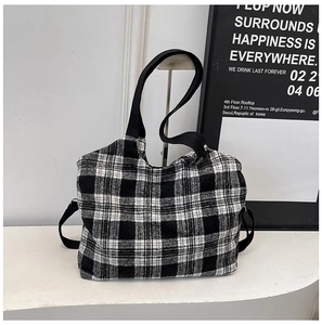 Detail shot of the textured black and white plaid pattern on this large tote bag