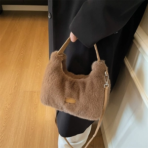 Brown faux fur plush handbag with leather patch and detachable shoulder strap in a stylish scene