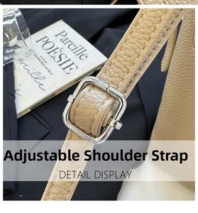 Detail of adjustable khaki lychee leather shoulder strap with silver metal buckle