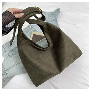 Detail of adjustable bronze buckle on dark olive suede hobo bag with denim texture