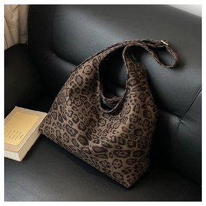 Close-up of leopard print suede tote bag with thick fabric texture and wide shoulder strap