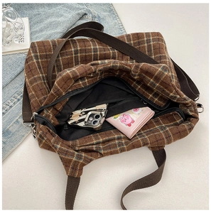 Detailed interior of brown plaid tote bag showing canvas lining and daily storage capacity