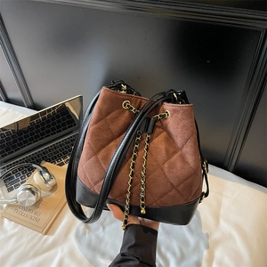 Chic brown quilted drawstring bucket bag with black leather trim and golden chain strap