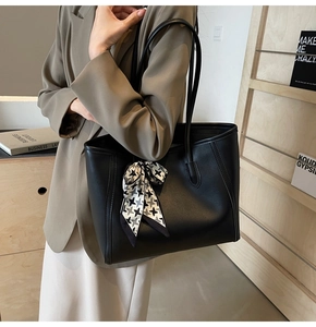 Detail of black matte tote bag with houndstooth scarf accessory for business casual style