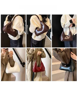 Detail view of crescent shoulder bags in multiple colors with high-gloss finish textures