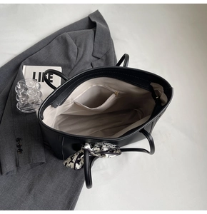 Top view of spacious interior of black leather tote bag with silk scarf and inner zipper pocket