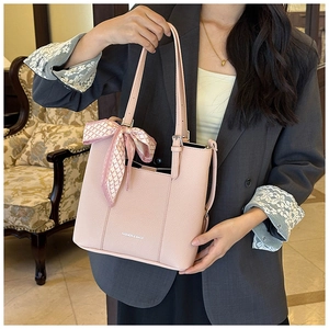Detail of pink faux leather tote bag with silk scarf handle and FASHION & BAGS print