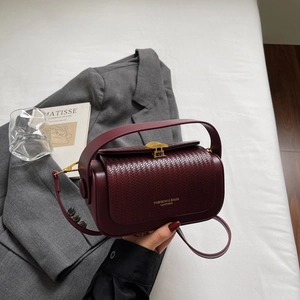 Vintage burgundy box bag with woven flap and gold clasp for office style