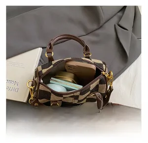 Top-down view of checkered canvas bag interior showing phone, lipstick, and cosmetics