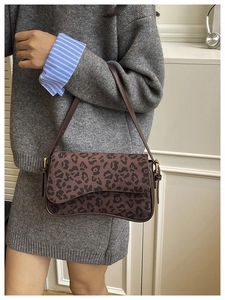 Close-up of leopard print underarm bag in dark brown suede with premium leather strap