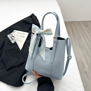 Light blue lychee leather handbag with decorative silk scarf and fashion logo