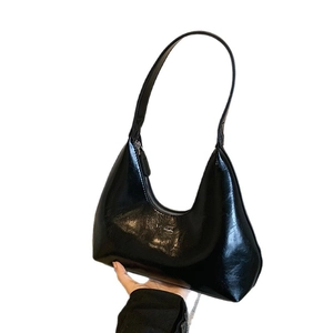 Fashionable black glossy crescent hobo bag with metal logo and zipper closure