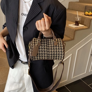 Classic houndstooth Boston bag with dark brown leather handles and wide shoulder strap