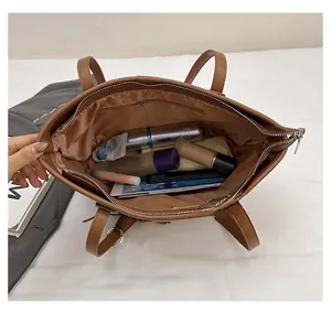 Top view of spacious interior in brown tote bag showing pocket and zipper detail