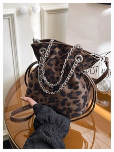 Detail of leopard print bucket bag with silver chain and leather drawstring closure