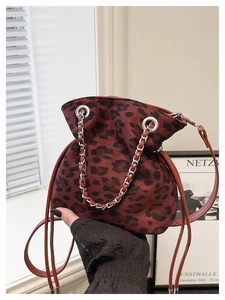 Detail of burgundy leopard bucket bag with silver chain handle and drawstring closure