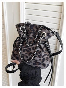 Close-up of leopard print bucket bag with silver chain strap and drawstring closure