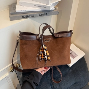 Quilted dark brown suede tote bag with wooden bead charm and long shoulder strap