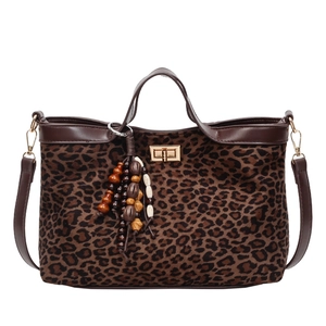 Large leopard print tote bag with brown handles and vintage beaded tassel ornament