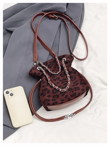 Detail of leopard print bucket bag with silver chain and adjustable leather strap