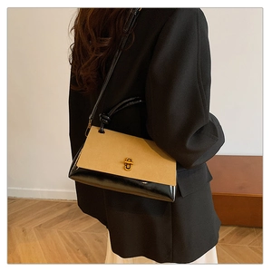 Detail of the suede patchwork square bag showing the gold metal turn-lock and leather strap