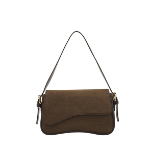 Deep brown matte suede underarm bag with curved flap and gold buckle on white background