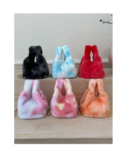 Detail of plush crossbody bags with gold chain straps in six marbled color patterns