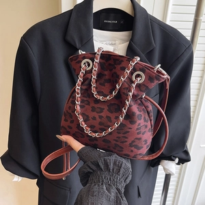 Leopard print drawstring bucket bag with silver chain handle and crossbody strap